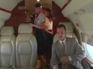 Concupiscent stewardesses suck their clients hard member on the plane